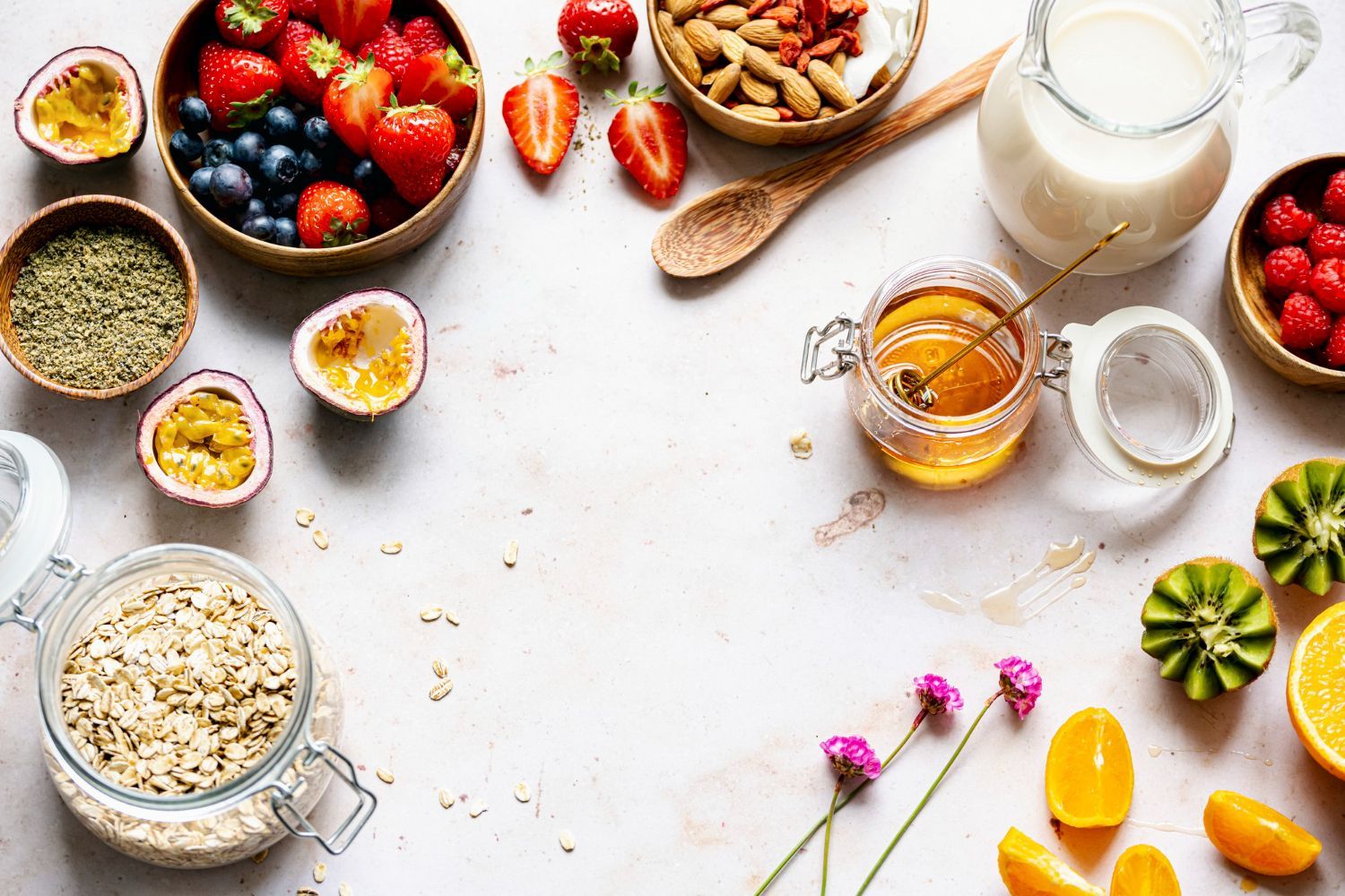 Colorful fruit and nuts with honey on white background.