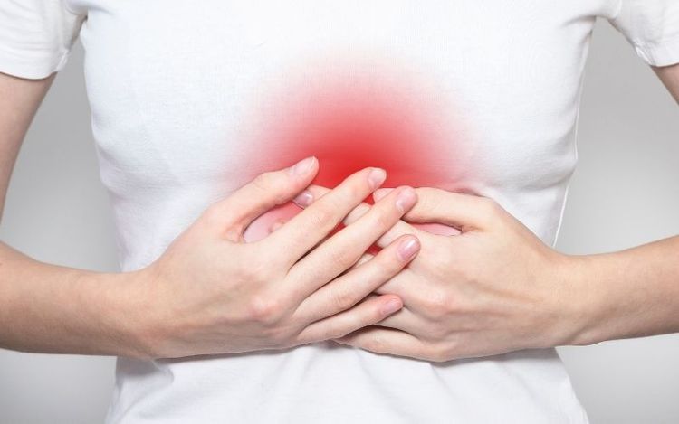 Person clutching stomach with visible pain or discomfort.