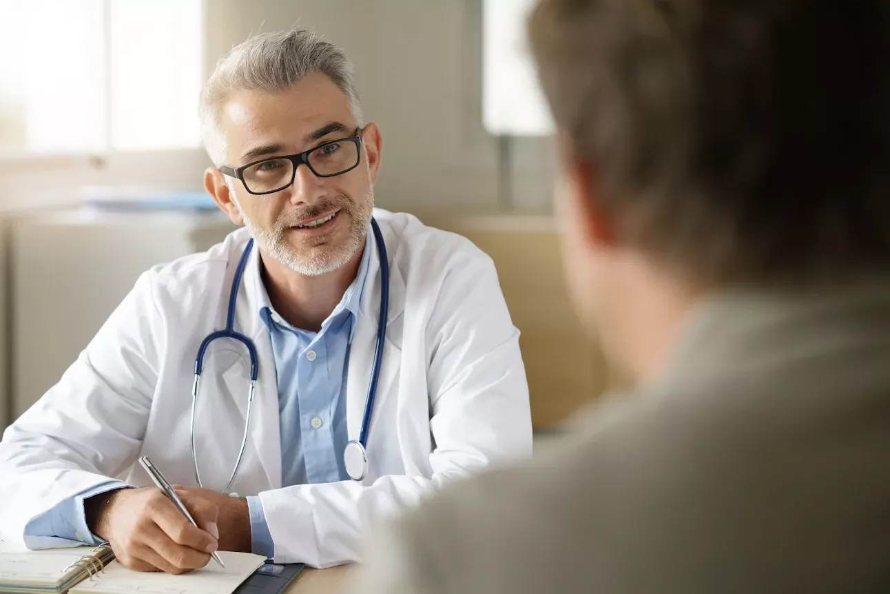 Doctor consulting with a patient in an office.